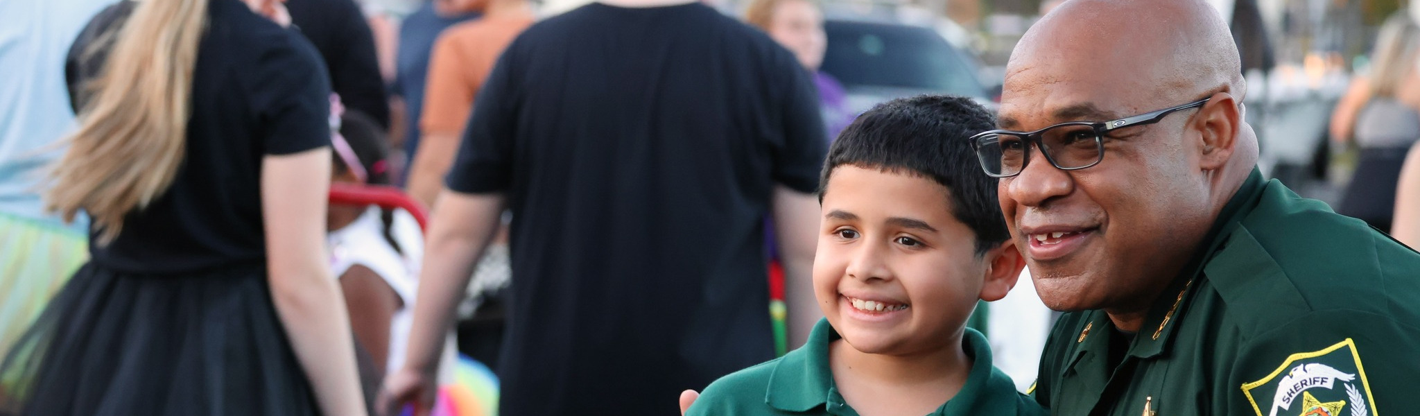 Undersheriff Canty posing with a kid