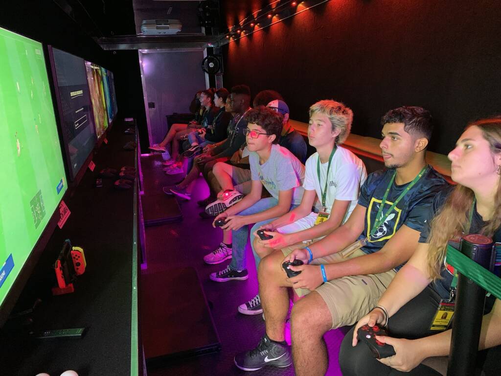 teen academy playing in the video game trailer