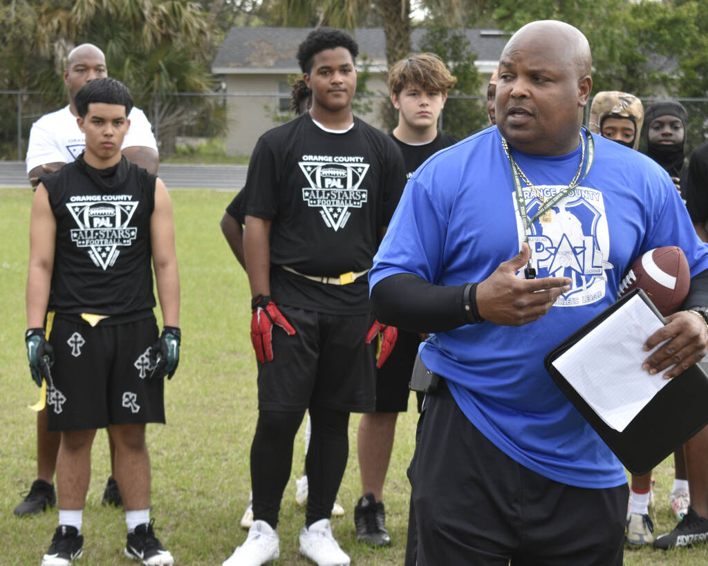 PAL coach instructing group of kids
