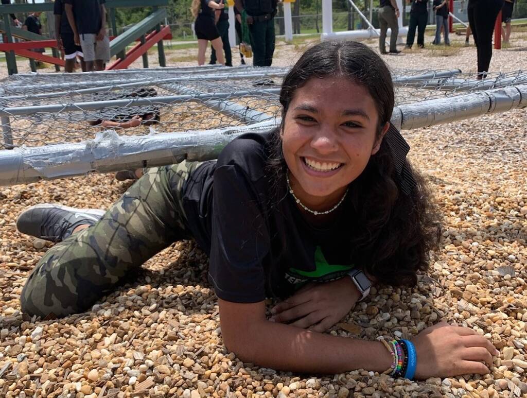 kid crawling through an obstacle