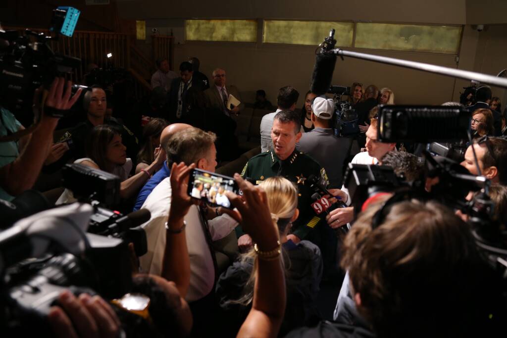 Sheriff Mina surrounded by press