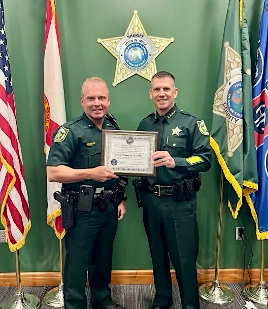 Sheriff Mina presenting The LGBTQ Accreditation certificate to the LGBTQ liaison