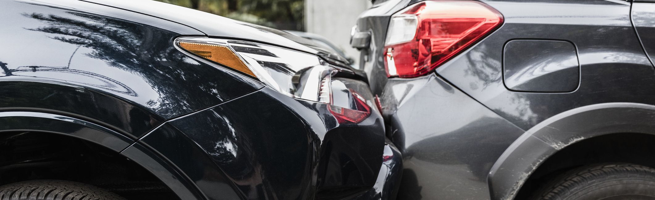 A black car hitting the back of a gray car