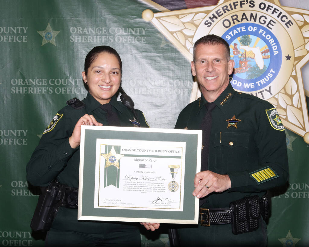 Sheriff Mina presenting an award to a female deputy