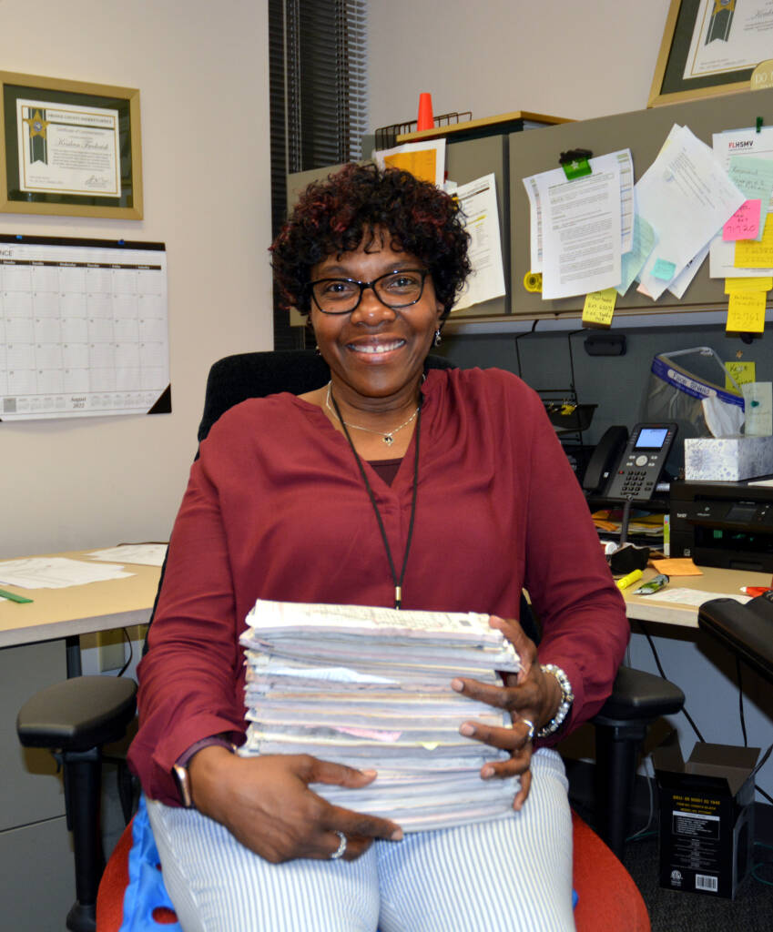 Civilian employee holding a stack of documents