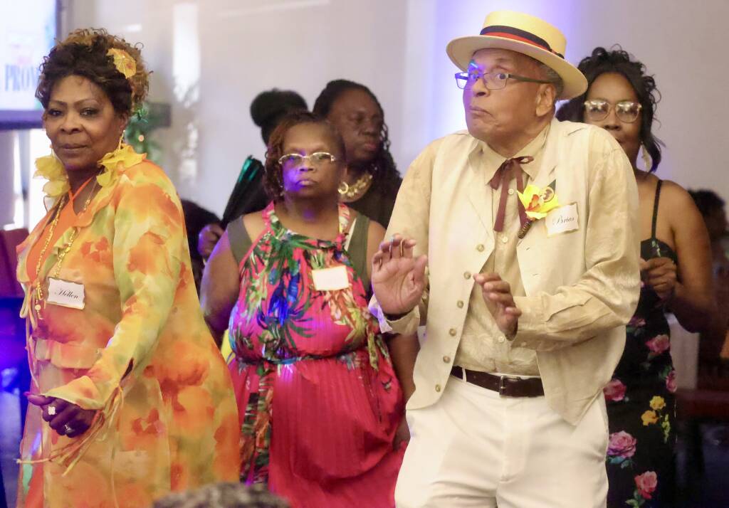 A group dancing in tropical prom attire