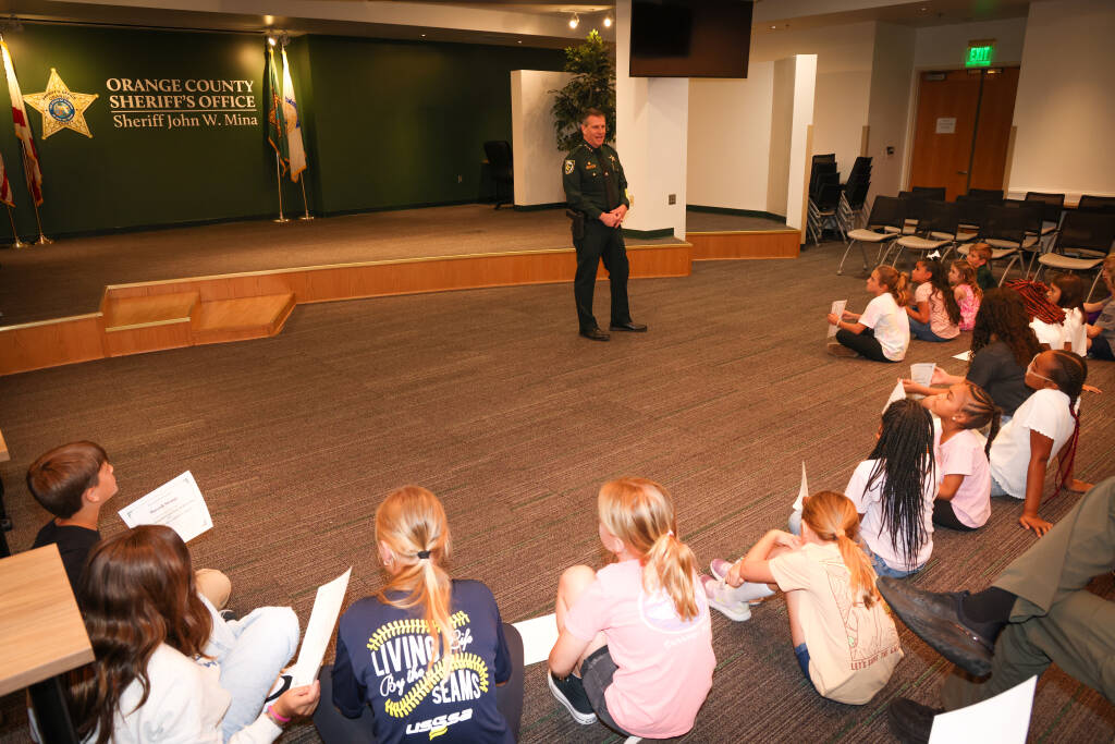 Sheriff Mina speaking to a room of children